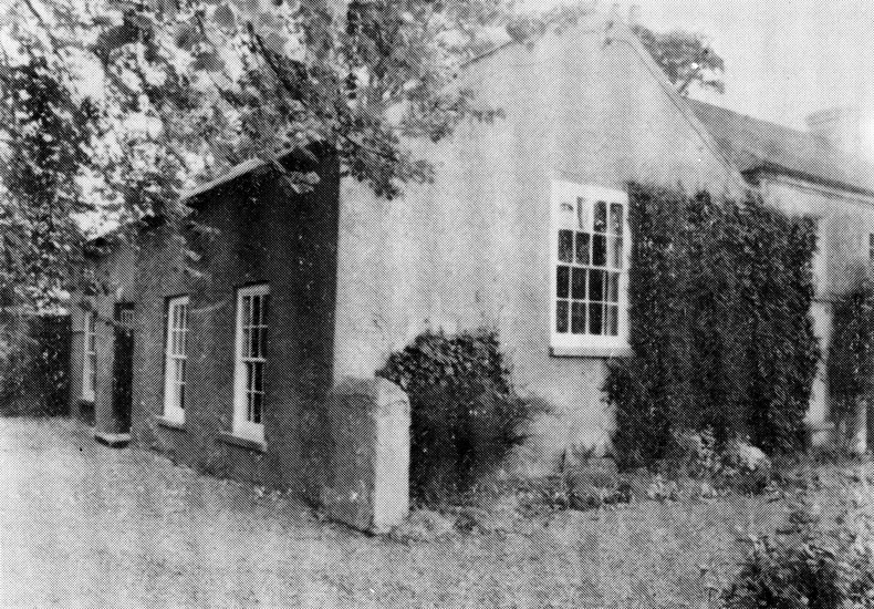 Exterior of the Old Meeting House adjoined by the Caretaker's Premises and the site of the Original Meeting House